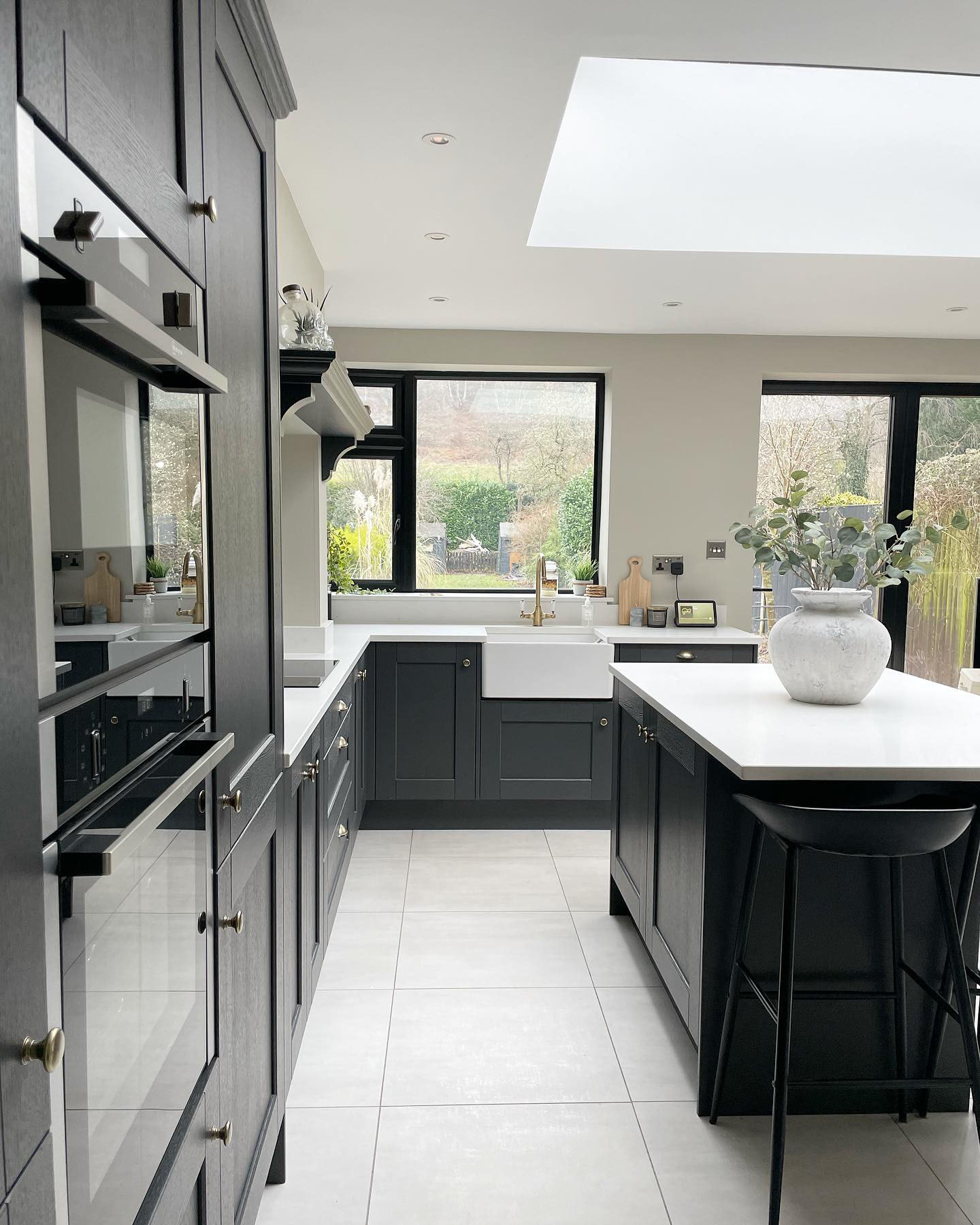 Renovated dark kitchen with black vidaXL barstools